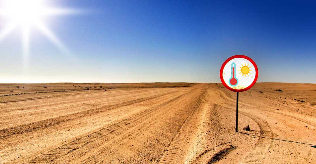 Airius-Cooling-For-Summer Extreme heat warning sign in arid landscape illustrating summer cooling challenges.