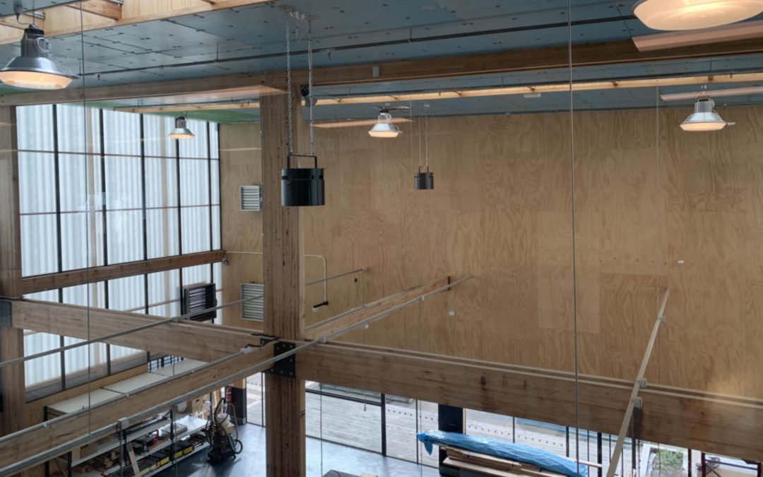 Large warehouse space with Airius destratification fans and high ceilings, improving airflow and energy savings.