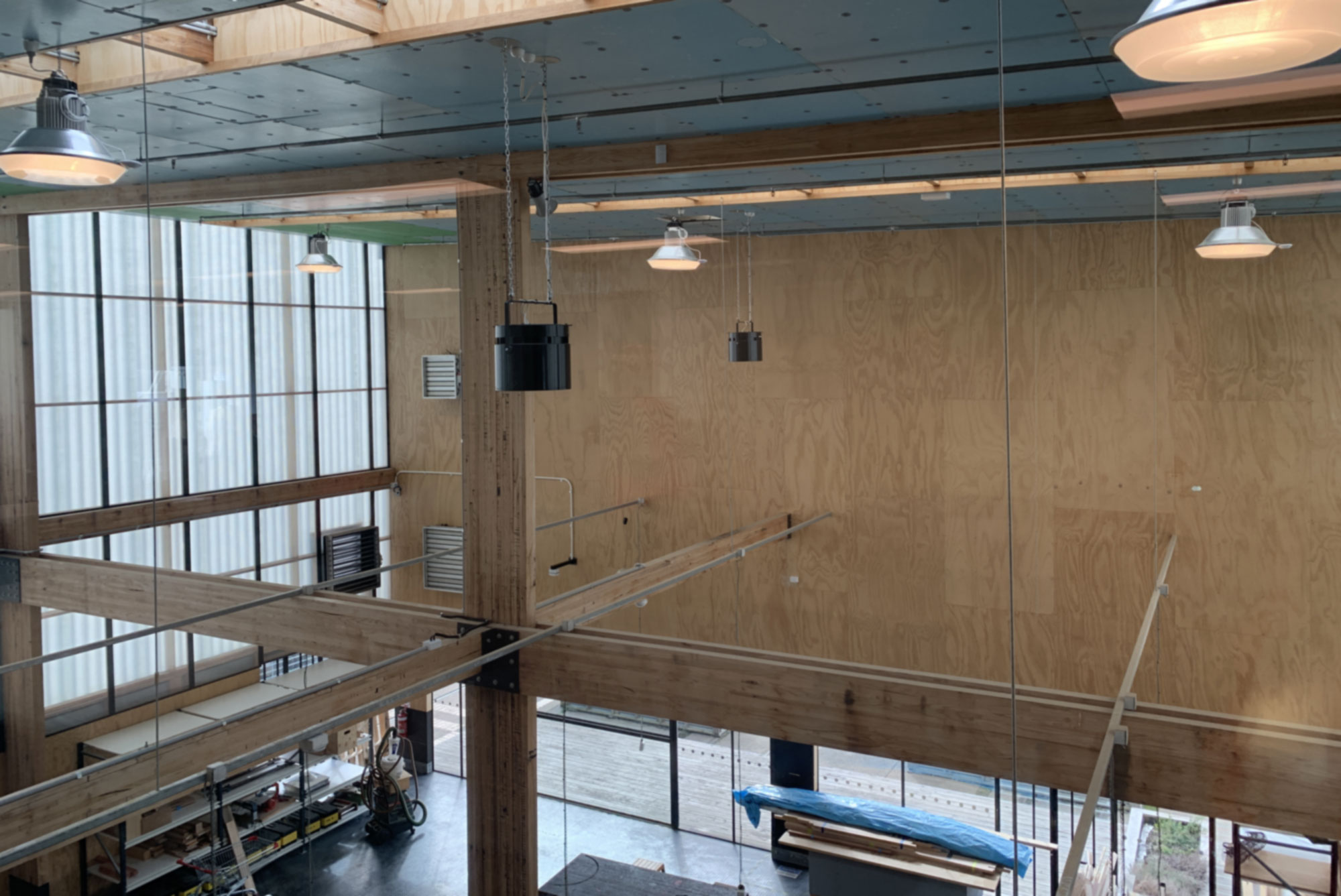 UTAS-4 Airius destratification fans installed in a large warehouse space, improving cooling and occupant safety.