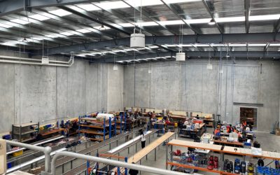 Warehouse interior with Airius destratification fans improving air circulation and energy efficiency.