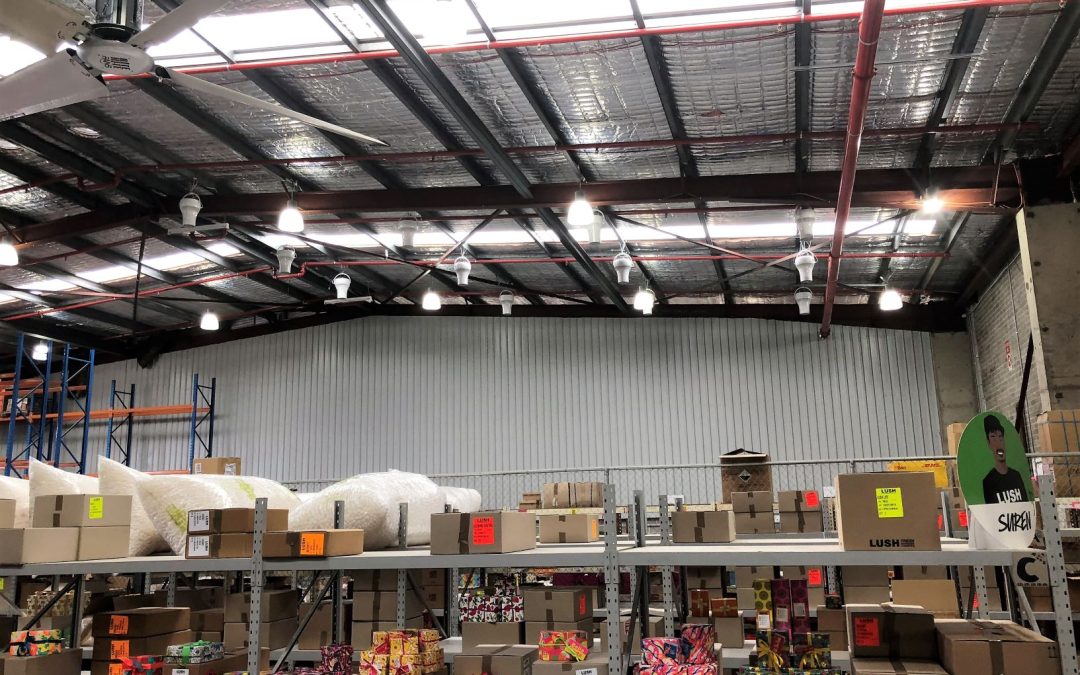 Airius destratification fans in a warehouse environment improving air circulation and energy savings.