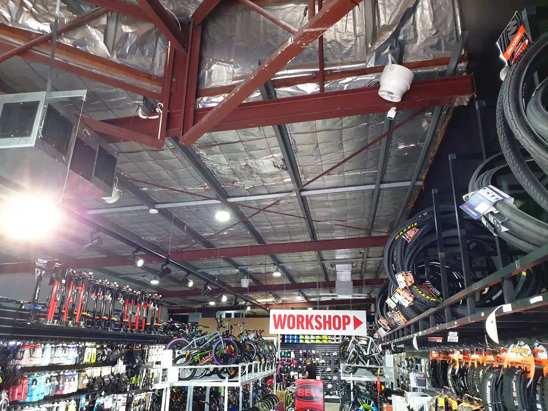 Airius Pearl Series fan installation in 99 Bikes retail space, open ceiling design and efficient