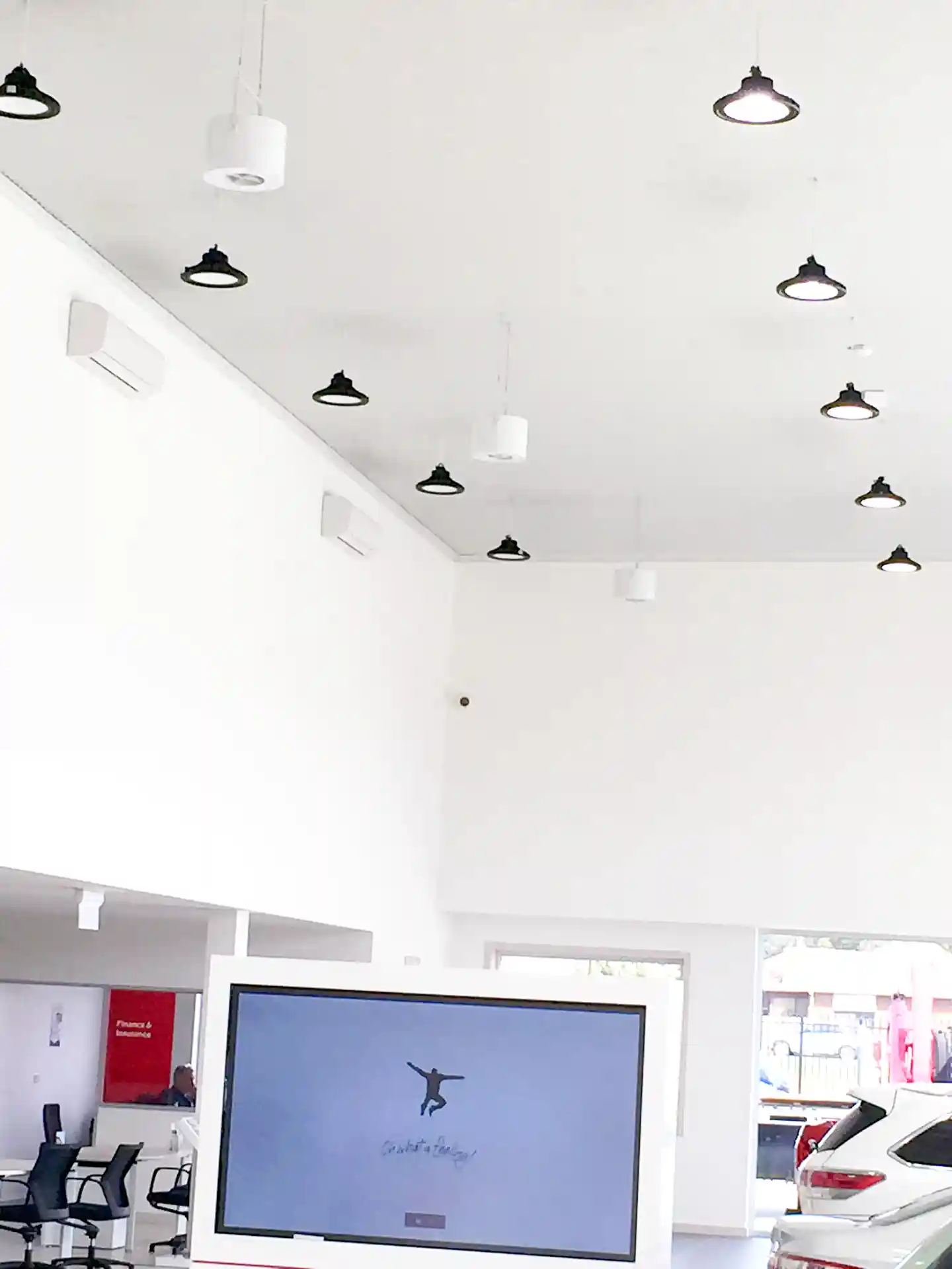 Airius Retail Series fans installed in Toyota showroom, Kilmore, blending with high bay lighting and