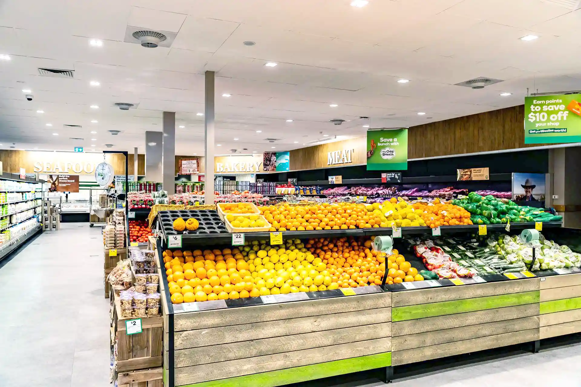 Supermarket produce section with Airius cooling fans improving air circulation and reducing condensation.