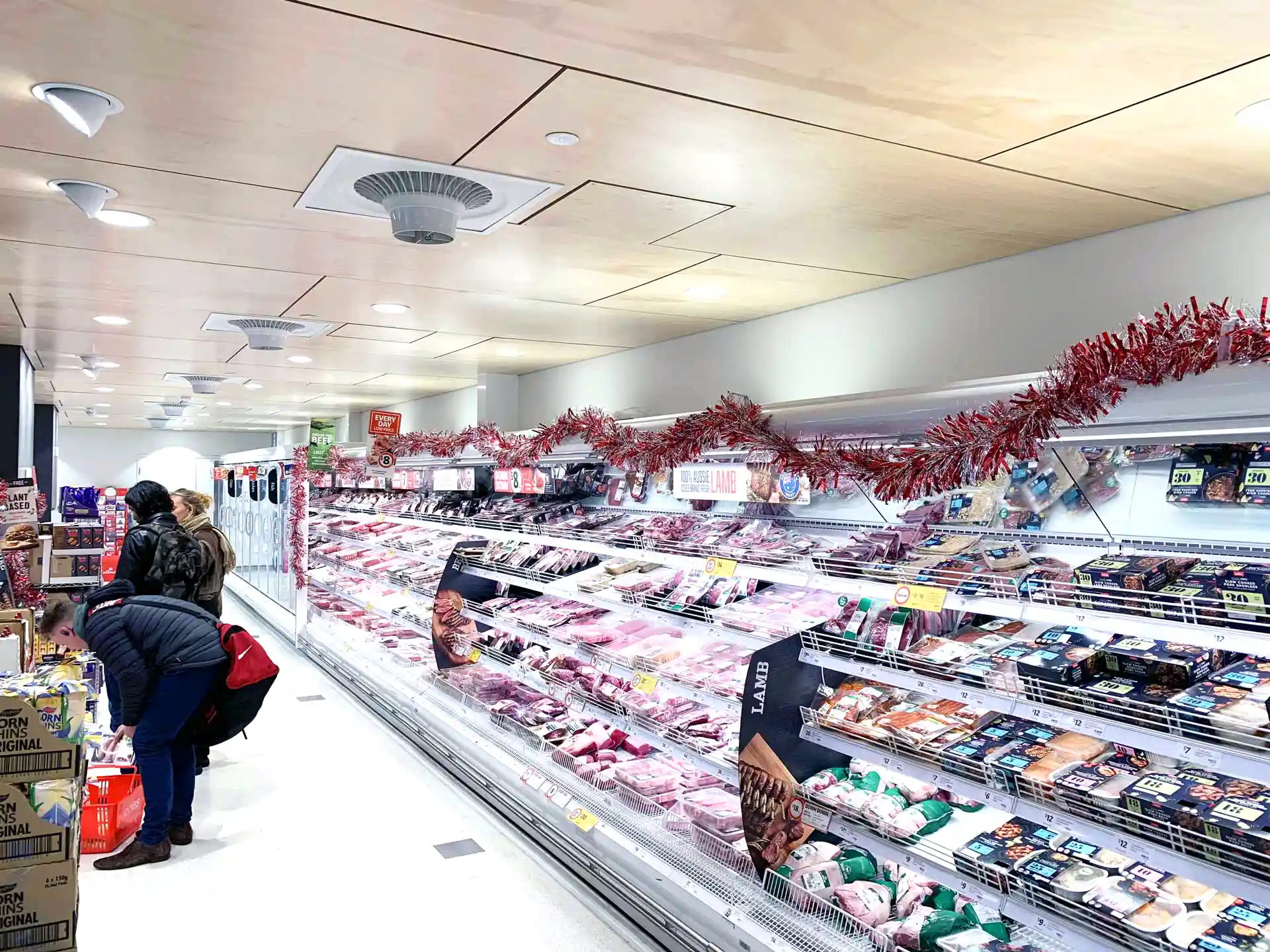 Supermarket aisle with Airius cooling fans improving air circulation and reducing condensation on refrigerated display