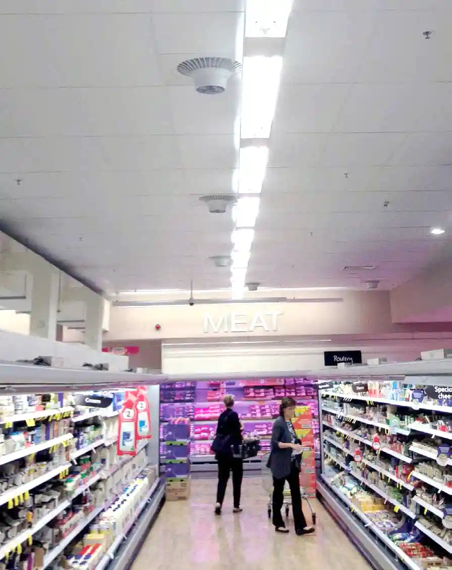 Airius cooling fan installation in supermarket aisle, improving air circulation and reducing condensation.