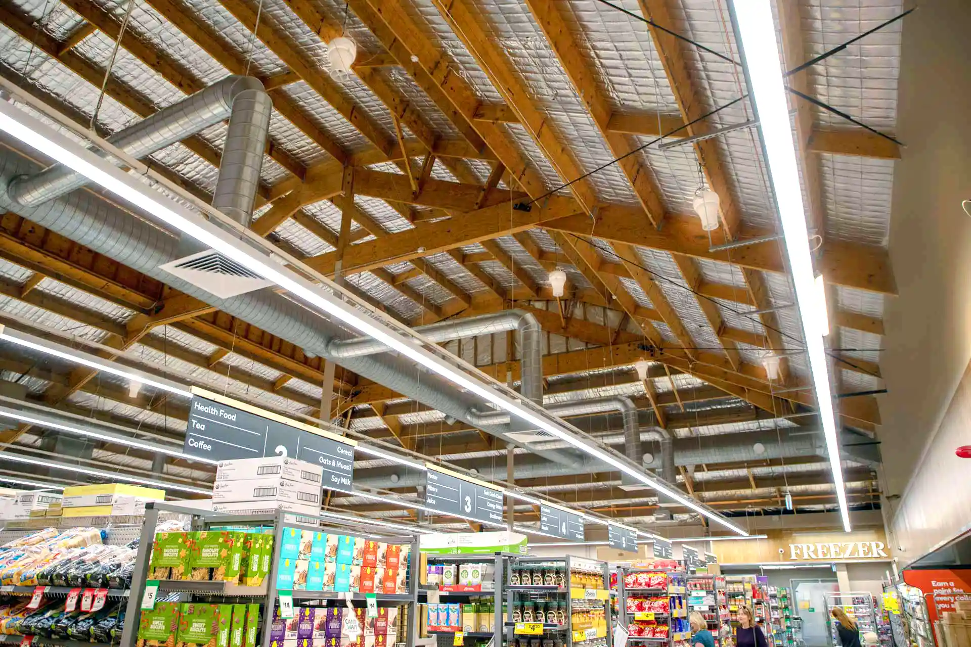 Airius cooling fans installed in supermarket ceiling, improving air circulation and reducing condensation.