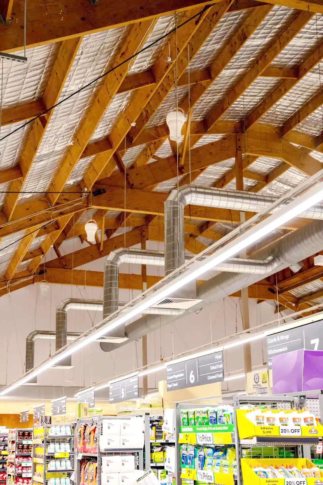 Airius cooling fans installed in supermarket ceiling, improving air circulation and reducing condensation on fridge