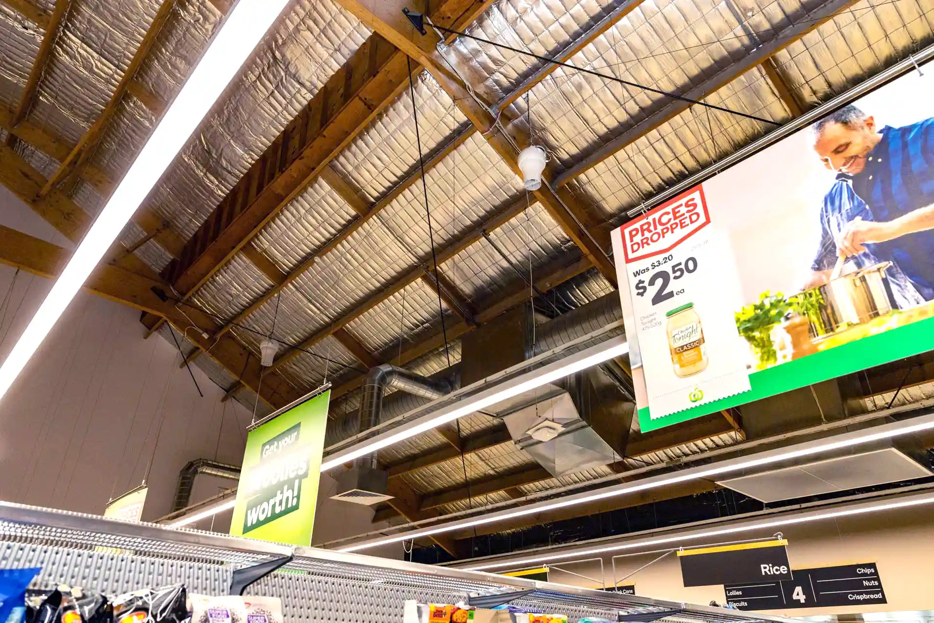 Airius cooling fan installation in supermarket aisle, improving air circulation and reducing condensation on freezer