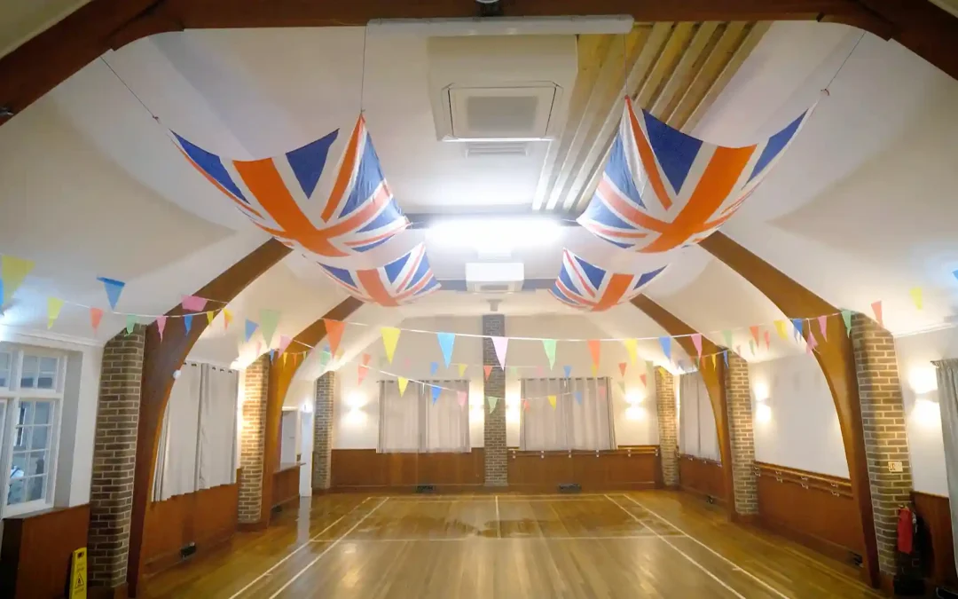 Airius destratification fans improving comfort at Eversley Village Hall, featuring Union Jack decorations and high