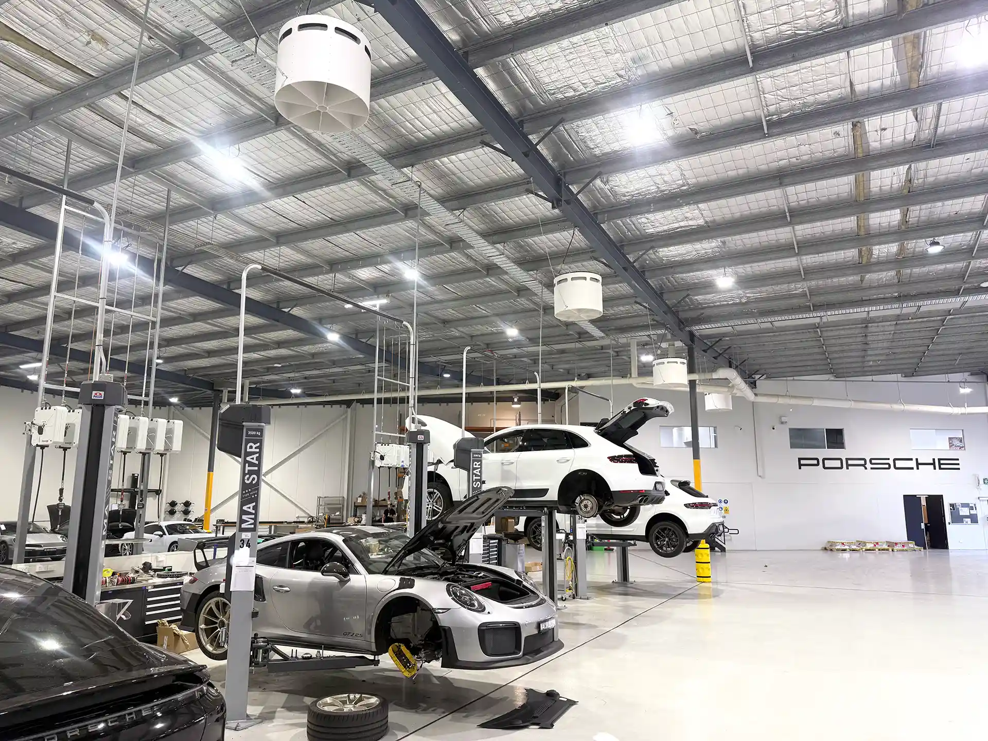 Airius Emerald fans installed in Porsche Centre Sydney South service bays, improving airflow and comfort