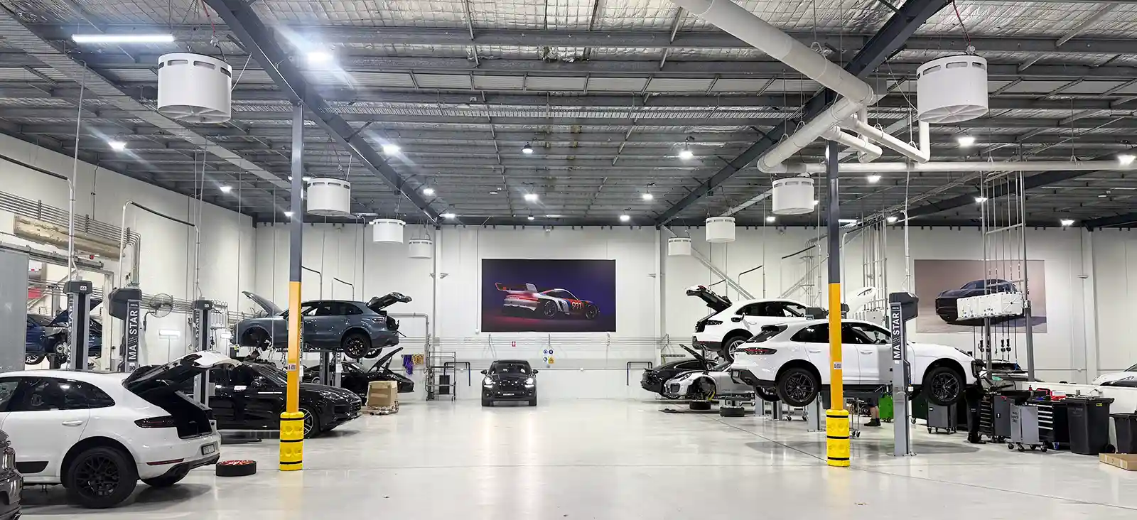 Porsche Centre Sydney South Workshop – Airius Emerald Series Fans Airius Emerald fans in Porsche Centre Sydney South workshop providing airflow solutions and destratification.