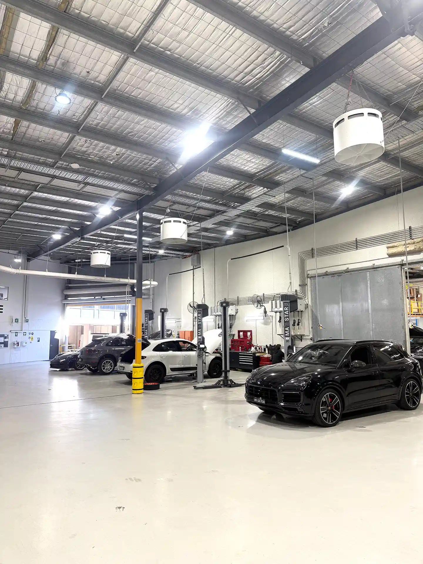 Porsche Centre Sydney South workshop featuring Airius Emerald 630EC airflow fans for improved cooling and