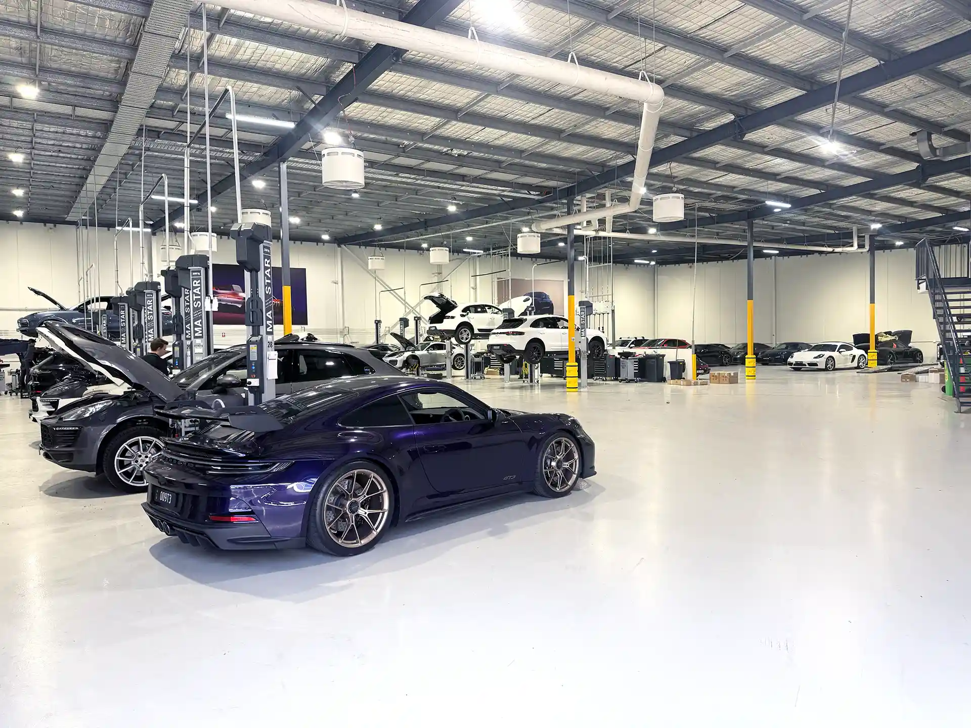 Porsche Centre Sydney South automotive workshop with Airius fans providing airflow cooling and destratification.