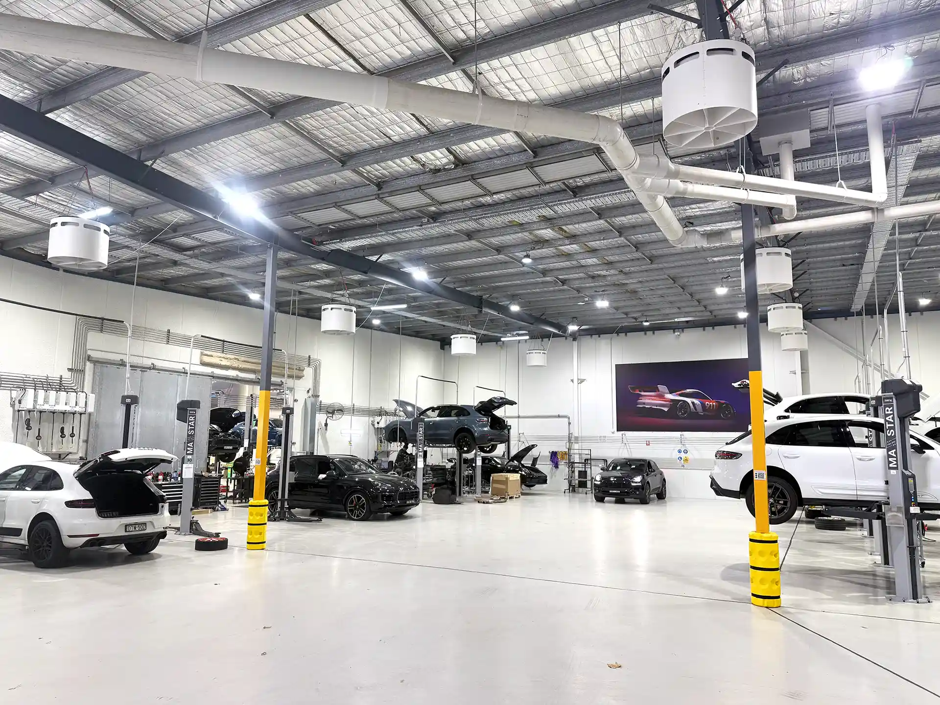 Porsche Centre Sydney South workshop with Airius Emerald fans providing airflow cooling and destratification.